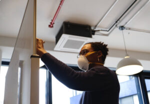 man installing a comercial wood door